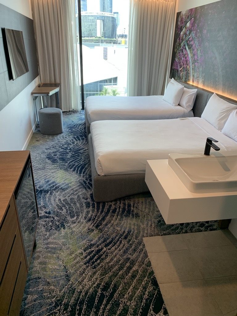Patterned carpet in a twin hotel guest room
