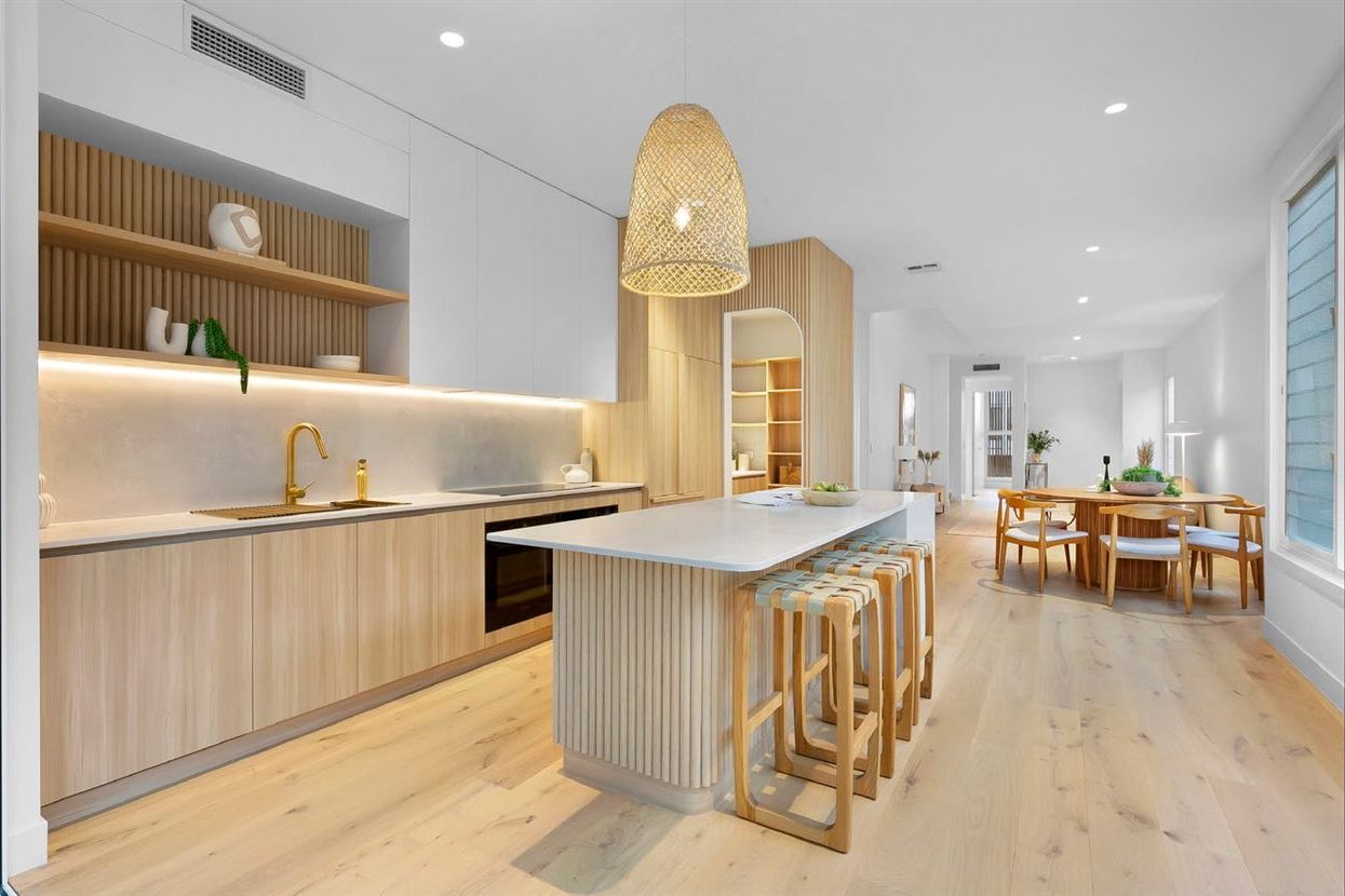 Wide-board oak timber flooring in a coastal kitchen and dining area